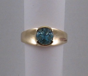 Ring with medium blue lone star topaz, yellow gold.